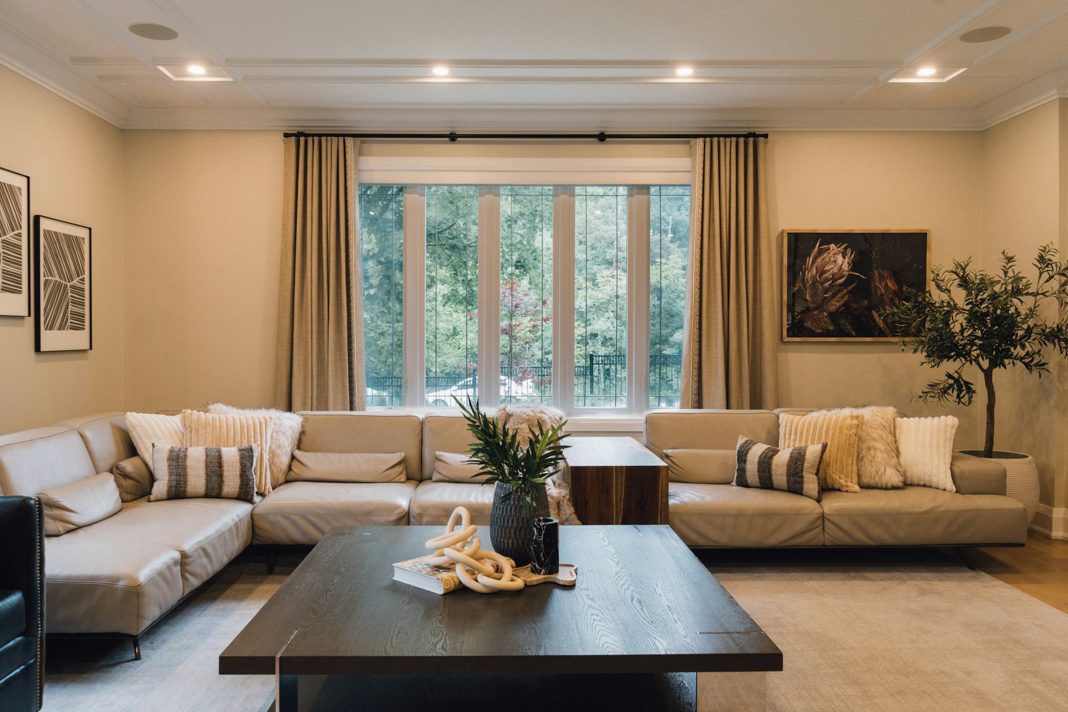 Living room with grey furnishings beside a large window