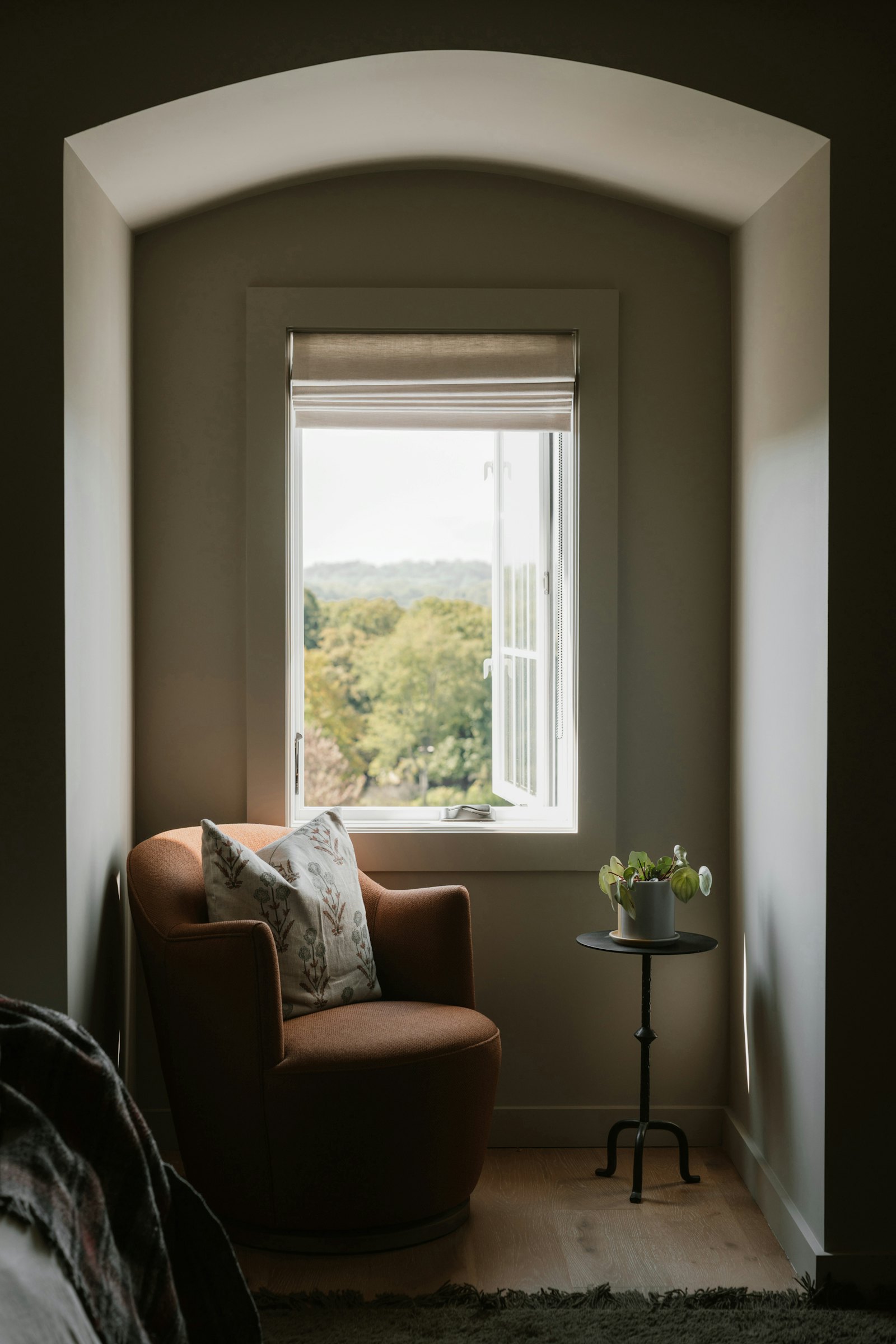 Armchair beside a window overlooking a garden
